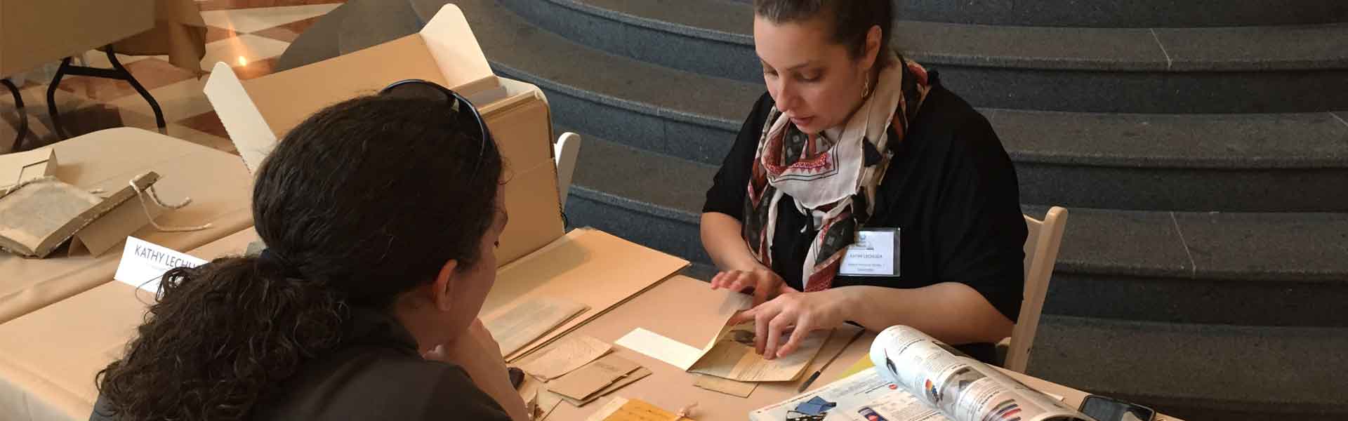 Conservator consults with client on historic documents.