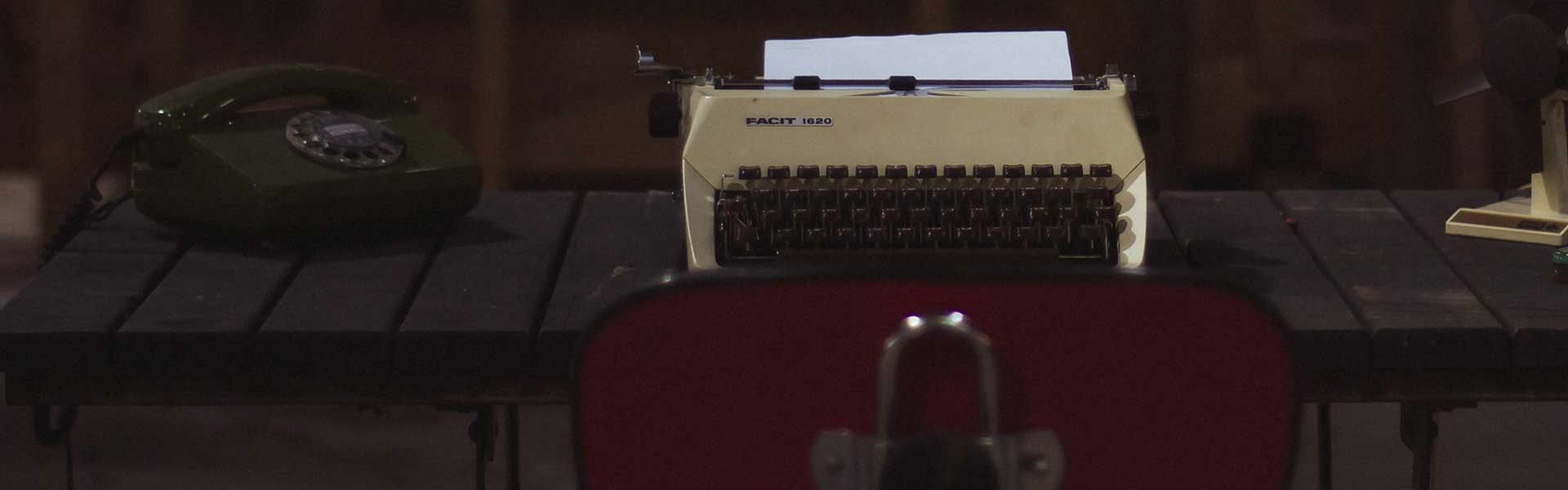 desk with rotary telephone and typewriter