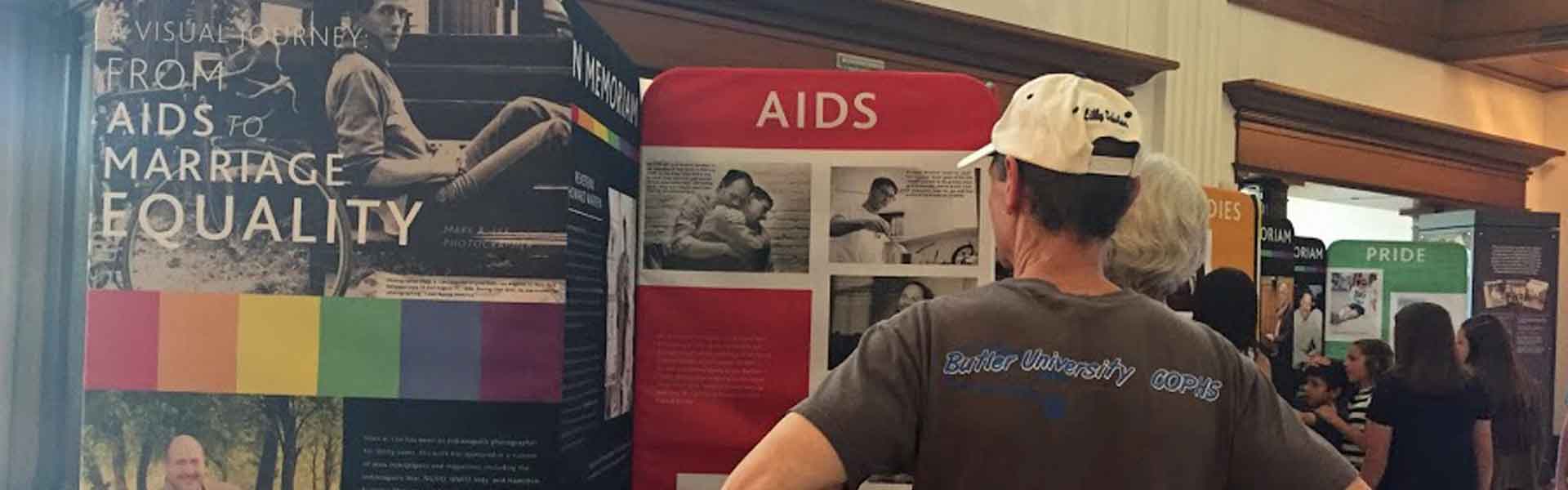Man looking at LGBT Traveling Exhibit