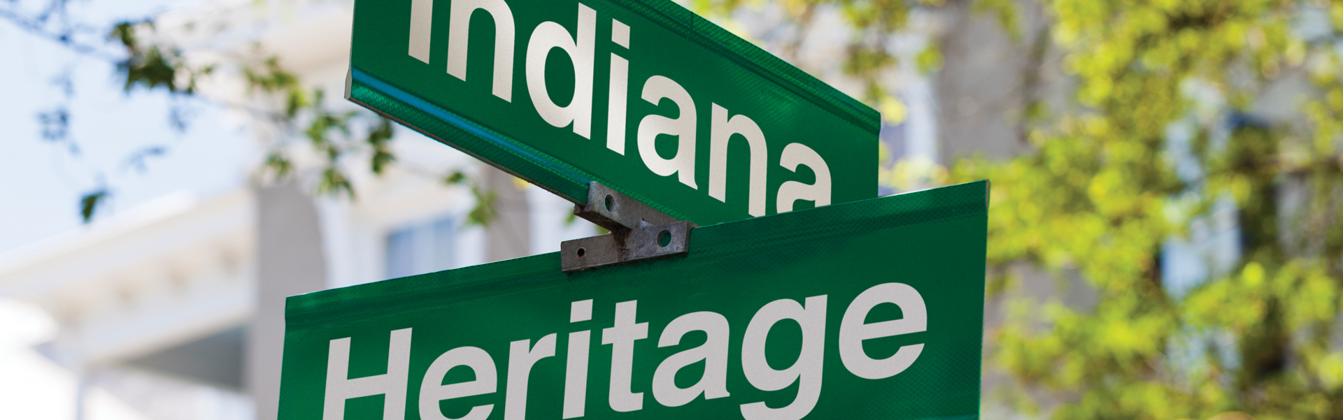 Crossing street signs. Sign on top says Indiana. Sign on bottom says Heritage.